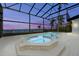 Gorgeous pool and spa area with stunning water view under screened enclosure at 4620 Riverview Blvd, Bradenton, FL 34209