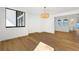 Bright, spacious room with hardwood floors and modern lighting fixture, open to kitchen area at 4620 Riverview Blvd, Bradenton, FL 34209