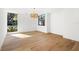 Bright room features hardwood floors, modern lighting fixture and a view of lush greenery at 4620 Riverview Blvd, Bradenton, FL 34209