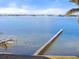 Idyllic waterfront scene with a long wooden dock stretching into the bay, framed by blue skies at 4620 Riverview Blvd, Bradenton, FL 34209