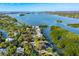 Breathtaking aerial view of waterfront home near the bay, nestled among lush greenery at 5236 Siesta Cove Dr, Sarasota, FL 34242