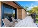 Relaxing balcony with wooden chairs, wood siding, black window frames, and beautiful views at 5236 Siesta Cove Dr, Sarasota, FL 34242