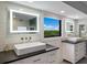 Bright bathroom featuring dual sinks, white cabinetry, and a lovely outdoor view at 5236 Siesta Cove Dr, Sarasota, FL 34242
