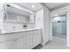 Elegant bathroom with double vanity, marble countertops, and a glass-enclosed shower at 5236 Siesta Cove Dr, Sarasota, FL 34242
