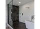 A modern bathroom featuring glass shower, luxurious tub, and white textured tile at 5236 Siesta Cove Dr, Sarasota, FL 34242