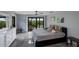 Stylish bedroom with a comfortable bed, access to a private balcony, and serene decor at 5236 Siesta Cove Dr, Sarasota, FL 34242