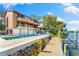 Stunning home with a pool, private boat dock, and multiple balconies overlooking the water at 5236 Siesta Cove Dr, Sarasota, FL 34242