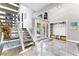 Bright foyer features tiled floors, high ceilings, and stairway to upper level at 5236 Siesta Cove Dr, Sarasota, FL 34242