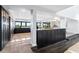 Open-concept kitchen boasts dark cabinetry, stainless steel appliances, and a seamless flow into the living area at 5236 Siesta Cove Dr, Sarasota, FL 34242