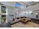 Open-concept living room with a large sectional sofa, two-story staircase, and ample natural light at 5236 Siesta Cove Dr, Sarasota, FL 34242