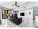 Spacious living room with theater seating, tiled floor, and lots of natural light at 5236 Siesta Cove Dr, Sarasota, FL 34242