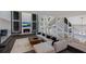 Open living area with fireplace, contemporary decor, and staircase leading to the second floor at 5236 Siesta Cove Dr, Sarasota, FL 34242