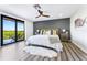 Spacious main bedroom with hardwood floors and balcony access with peaceful outdoor views at 5236 Siesta Cove Dr, Sarasota, FL 34242