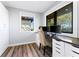 Bright office space with custom built-in desk and storage, with large windows providing natural light and views at 5236 Siesta Cove Dr, Sarasota, FL 34242