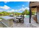 Inviting outdoor dining area with a grill and spiral staircase, perfect for waterfront entertaining and relaxation at 5236 Siesta Cove Dr, Sarasota, FL 34242