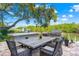 Charming outdoor dining space with a grill, set against a tranquil waterfront view, perfect for gatherings at 5236 Siesta Cove Dr, Sarasota, FL 34242