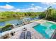 Breathtaking waterfront home features a pool, boat dock, and outdoor lounge area surrounded by lush scenery at 5236 Siesta Cove Dr, Sarasota, FL 34242