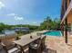 Outdoor dining area overlooking the pool and waterfront, perfect for entertaining at 5236 Siesta Cove Dr, Sarasota, FL 34242