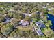 Aerial view showcasing a house, its manicured lawn, and surrounding neighborhood with pond at 6208 98Th E St, Bradenton, FL 34202