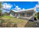 The home features a large, screened lanai and green backyard, perfect for outdoor living at 6409 Stone River Rd, Bradenton, FL 34203
