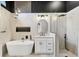 Modern bathroom featuring soaking tub, marble accents, and a glass enclosed shower at 6409 Stone River Rd, Bradenton, FL 34203