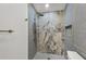 Renovated bathroom features gray tile, updated fixtures, a modern shower system, and a stylish tiled niche at 6409 Stone River Rd, Bradenton, FL 34203