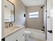 Bathroom featuring neutral tile, a shower, a sleek vanity, and black hardware accents at 6409 Stone River Rd, Bradenton, FL 34203