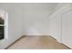 Inviting bedroom showcasing light wood floors, ample natural light from the window, and double door closets at 6409 Stone River Rd, Bradenton, FL 34203