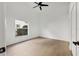 Bright bedroom boasts light wood floors, a ceiling fan, and a window overlooking the well-maintained outdoor space at 6409 Stone River Rd, Bradenton, FL 34203
