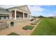 Clubhouse exterior with manicured lawn, adjacent to the golf course with practice range at 6409 Stone River Rd, Bradenton, FL 34203
