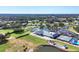 Aerial shot of the clubhouse, tennis courts, and meticulously landscaped community at 6409 Stone River Rd, Bradenton, FL 34203