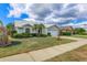 Attractive single-story home with manicured lawn, front garden, and a bright sky at 6409 Stone River Rd, Bradenton, FL 34203