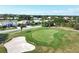 Scenic view of the lush golf course and sand trap within a serene residential community at 6409 Stone River Rd, Bradenton, FL 34203