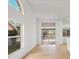 Open-concept living space featuring light wood floors, large windows, and sliding glass doors at 6409 Stone River Rd, Bradenton, FL 34203