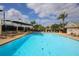 Enjoy resort-style living with this sparkling swimming pool and comfortable lounging area at Tara Golf and Country Club at 6409 Stone River Rd, Bradenton, FL 34203