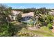 Aerial view of backyard, pool area and lush landscaping with waterfront view at 6922 Stanhope Pl, University Park, FL 34201