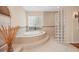 Bright bathroom featuring soaking tub, glass block shower, and neutral tile flooring at 6922 Stanhope Pl, University Park, FL 34201