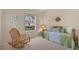 Cozy bedroom featuring a rocking chair and a daybed with a window view at 6922 Stanhope Pl, University Park, FL 34201