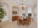 Inviting dining room features tile floors, a chandelier, arched doorways, and ample natural light at 6922 Stanhope Pl, University Park, FL 34201