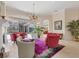 Cozy living room showcasing fireplace, neutral tile flooring, and access to screened-in pool at 6922 Stanhope Pl, University Park, FL 34201