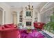 An elegant living room features a fireplace, built-in shelves and plenty of natural light at 6922 Stanhope Pl, University Park, FL 34201
