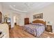 Spacious main bedroom with a large bed, natural light, and a connecting bathroom at 6922 Stanhope Pl, University Park, FL 34201