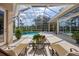 Screened-in lanai with pool, patio furniture, and lush landscaping at 6922 Stanhope Pl, University Park, FL 34201