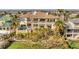 Aerial shot of expansive luxury home with pool, landscaping, and private dock on waterfront property at 7064 Hawks Harbor Cir, Bradenton, FL 34207