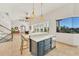 Kitchen with a seating bar and a view of the staircase, entry, and waterfront outside the window at 7064 Hawks Harbor Cir, Bradenton, FL 34207