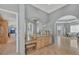 Spacious main bathroom featuring a large vanity with marble counter and arched doorways at 7064 Hawks Harbor Cir, Bradenton, FL 34207