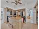 Spacious walk-in closet featuring custom shelves, storage, and island with marble counter at 7064 Hawks Harbor Cir, Bradenton, FL 34207