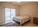 Cozy bedroom features tiled floor and slider with pool view at 7113 52Nd E Dr, Bradenton, FL 34203