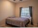 Neutral bedroom with a window overlooking the pool and a tile floor at 7113 52Nd E Dr, Bradenton, FL 34203