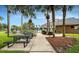 Community space with picnic tables and well maintained grounds surrounded by mature palm trees at 7113 52Nd E Dr, Bradenton, FL 34203